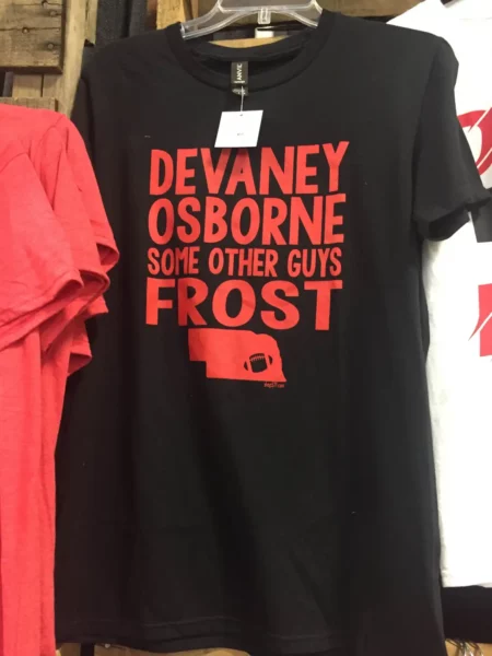 Black and red t-shirt with "Devaney, Osborne, Some Other Guys, Frost" text and the Nebraska state outline.